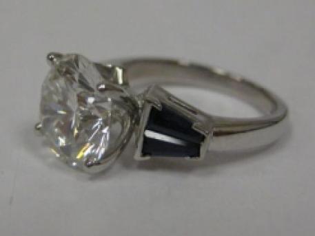3 carat Diamond Ring - Platinum Engagement Ring with 3 carat round diamond accented by custom hand cut Salon Sapphires. This design was made especially for one of our customers. Please contact us if you would like Blue Water Jewelers to design something similar for you!